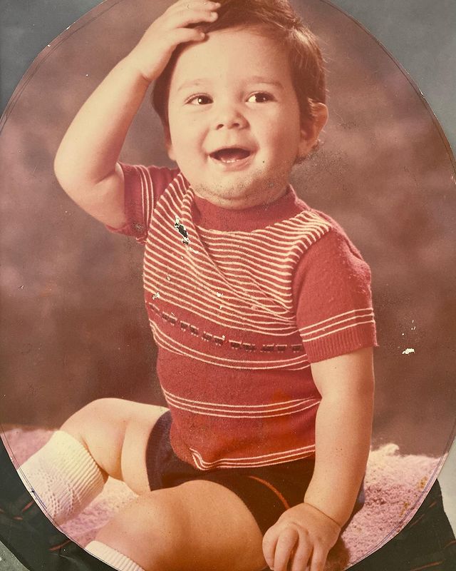 Childhood photo of J.R. Ramirez in a red t-shirt and black half pant.